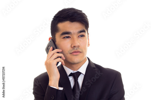 Young man in suit talking on the phone