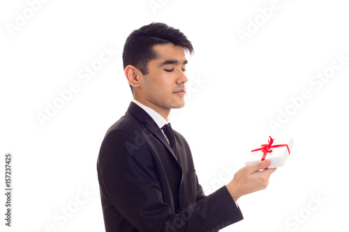 Young man in suit holding a present