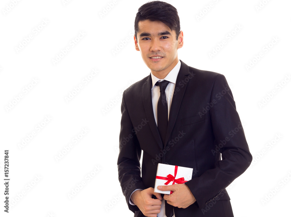 Young man in suit holding a present Young man in suit holding a present