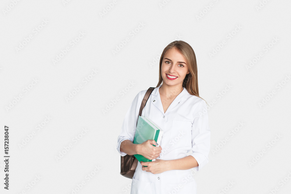 Smiling doctor with book in hands Smiling doctor with book in hands