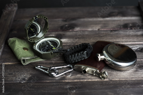 Travellers set for outdoor activity. Compass, watch, flask, carabiner