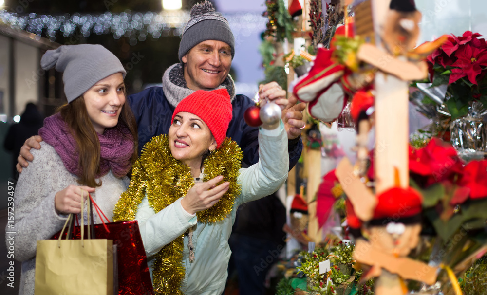 Portrait of family couple with teen girl at  Christmas fair