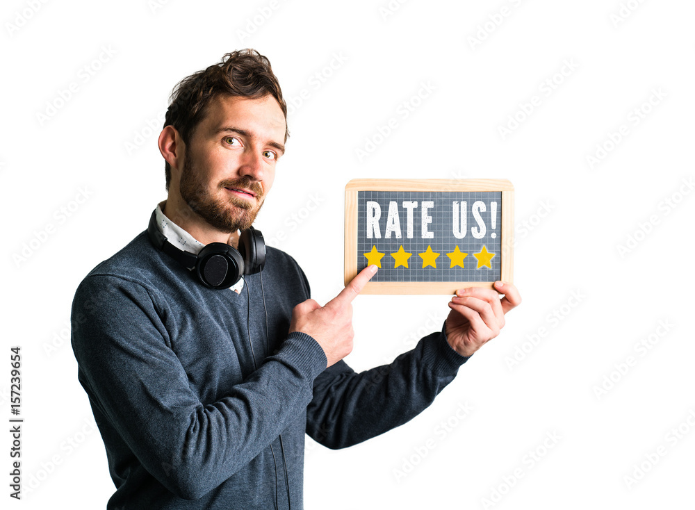 A young man holds a chalkboard saying A young man holds a chalkboard saying