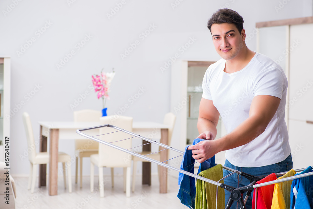 Man doing laundry at home Man doing laundry at home