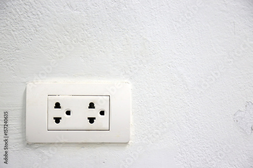 Outlet socket white color on white wall