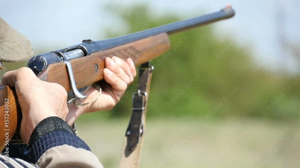 Amazing shot of a man shooting at some clay target while training skeet shooting with his smoothbare shotgun in a sunny day in autumn in slow motion. The man looks smart and professional Amazing shot of a man shooting at some clay target while training skeet shooting with his smoothbare shotgun in a sunny day in autumn in slow motion. The man looks smart and professional
