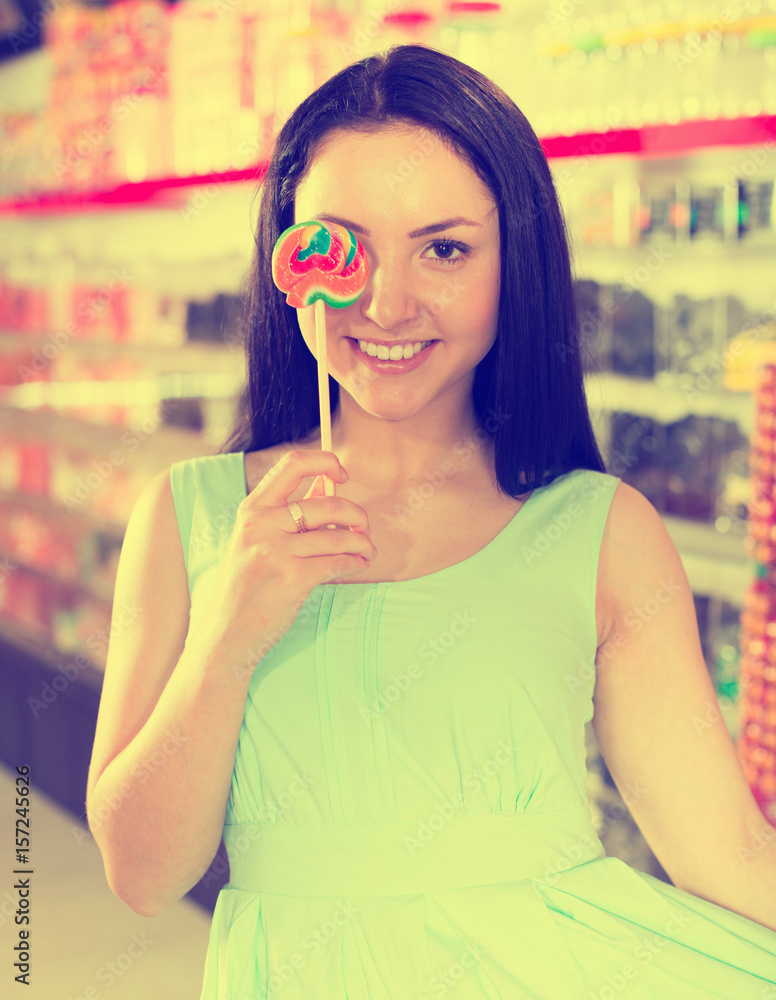 Smiling Girl Sucking Lollypop In Store Photos Adobe Stock 