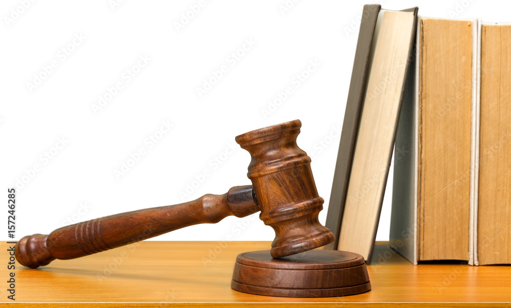 Wooden gavel and books on wooden table Wooden gavel and books on wooden table