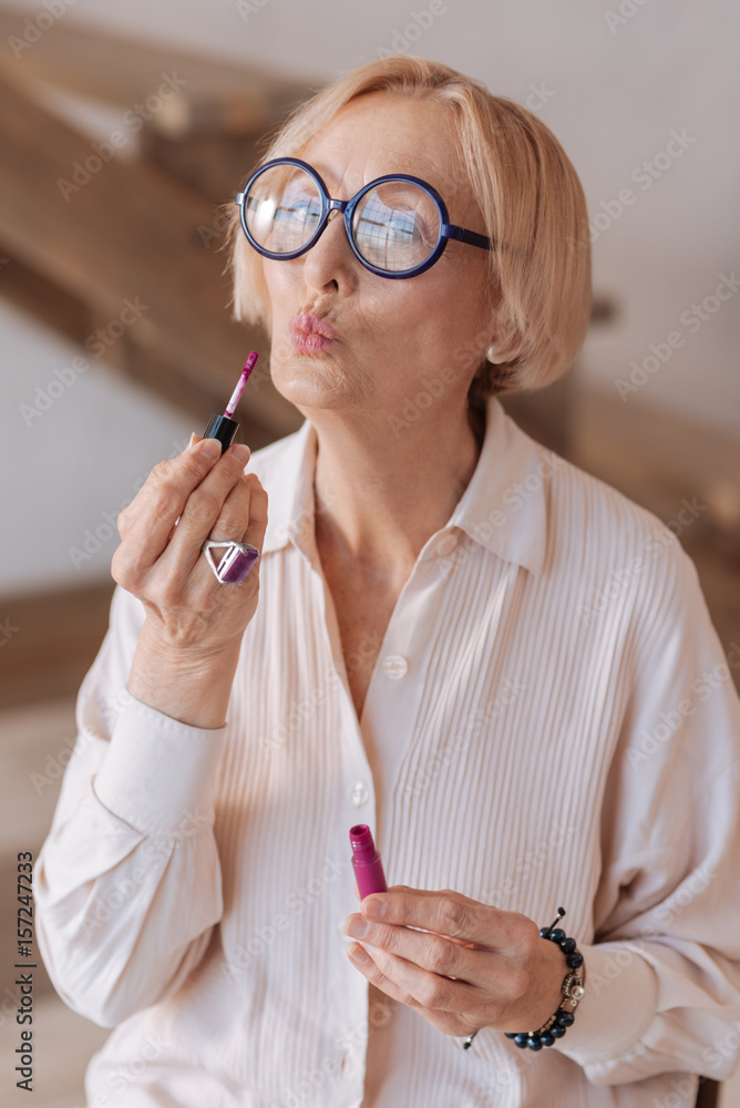 Charming grandmother posing on camera Charming grandmother posing on camera
