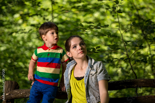 mother and son playing in the forest