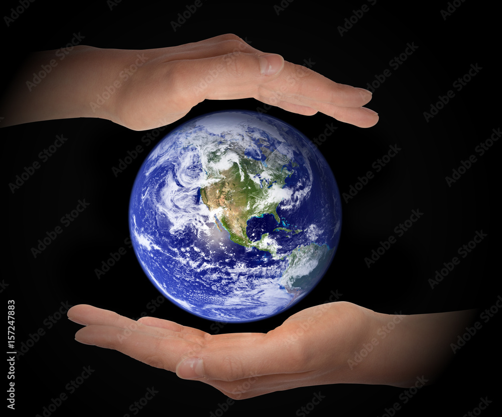 Glowing earth globe in hands on black background, environment concept - elements of this image furnished by NASA Glowing earth globe in hands on black background, environment concept - elements of this image furnished by NASA