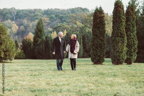 Mature couple walking in autumn park © LIGHTFIELD STUDIOS