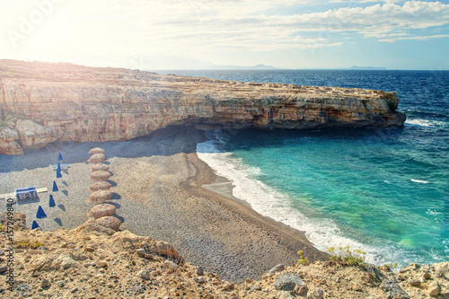 secluded beach with no people with rocks at sunrise