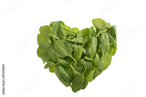 top view of heart shaped green spinach leaves isolated on white, food styling