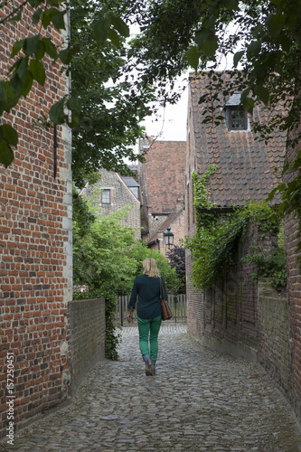 Beguinage Leuven Belgium. Walking in a small alley. photo