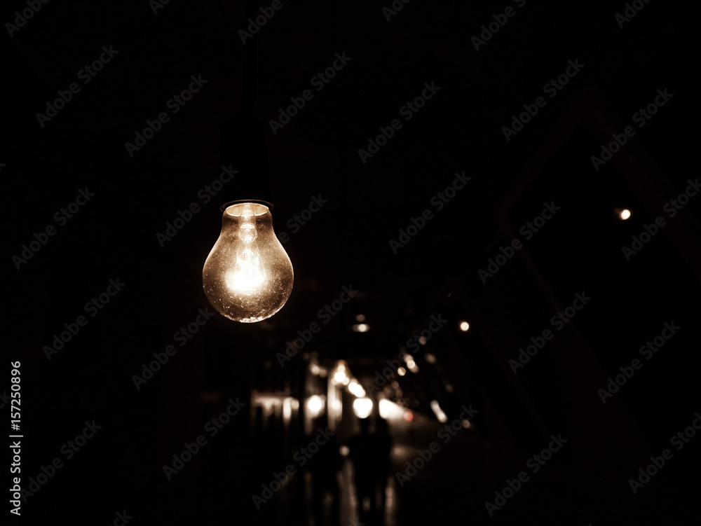 Hanging light bulb in darkness Hanging light bulb in darkness