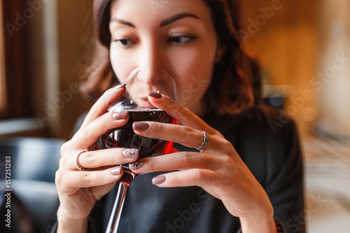Photos young asian woman drinks red wine in restaurant