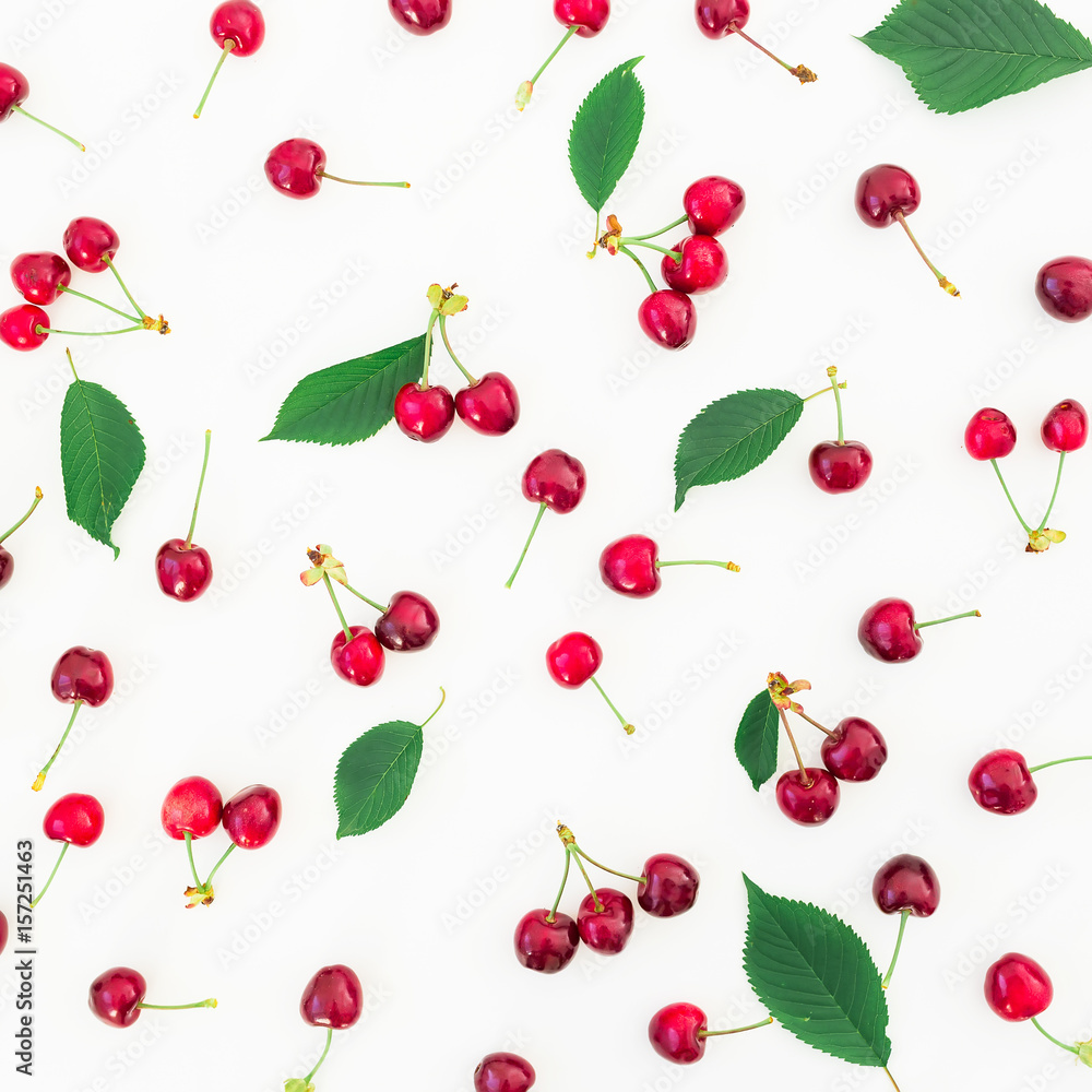 Pattern of cherries and leaves on white background. Flat lay. Top view. Summer berries Pattern of cherries and leaves on white background. Flat lay. Top view. Summer berries