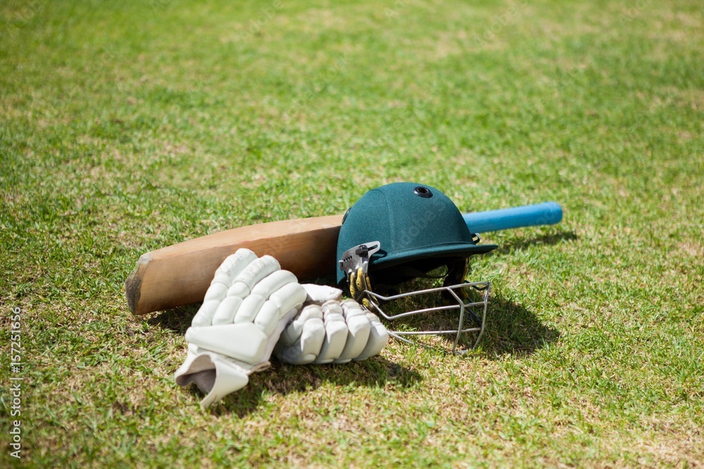 Naklejka premium High angle view of cricket equipment on field