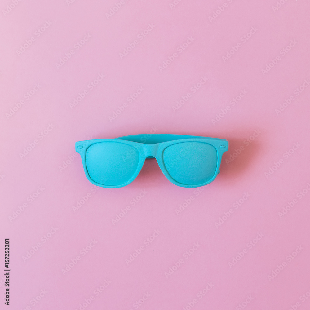 sunglasses painted in blue on a pink background. ultra minimal. flat lay. fashion summer. sunglasses painted in blue on a pink background. ultra minimal. flat lay. fashion summer.