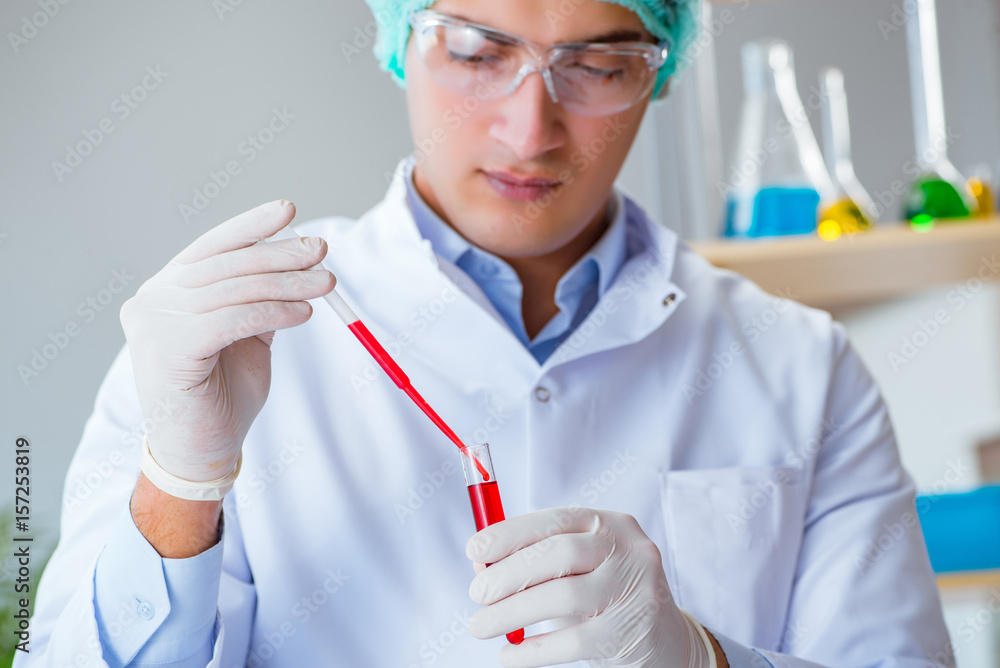 Young doctor working on blood test in lab hospital Young doctor working on blood test in lab hospital