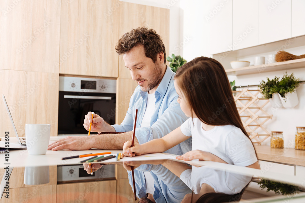 Fototapeta premium Daughter looking at drawing of her father