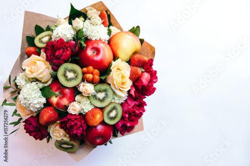 The original edible bouquet of marshmallow, apples, strawberries and flowers on white