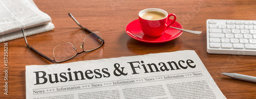 A newspaper on a wooden desk - Business and Finance