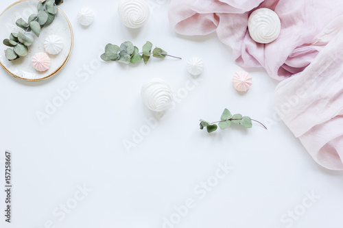 sweet marsh-mallow and flowers on woman white desk background top view mock up