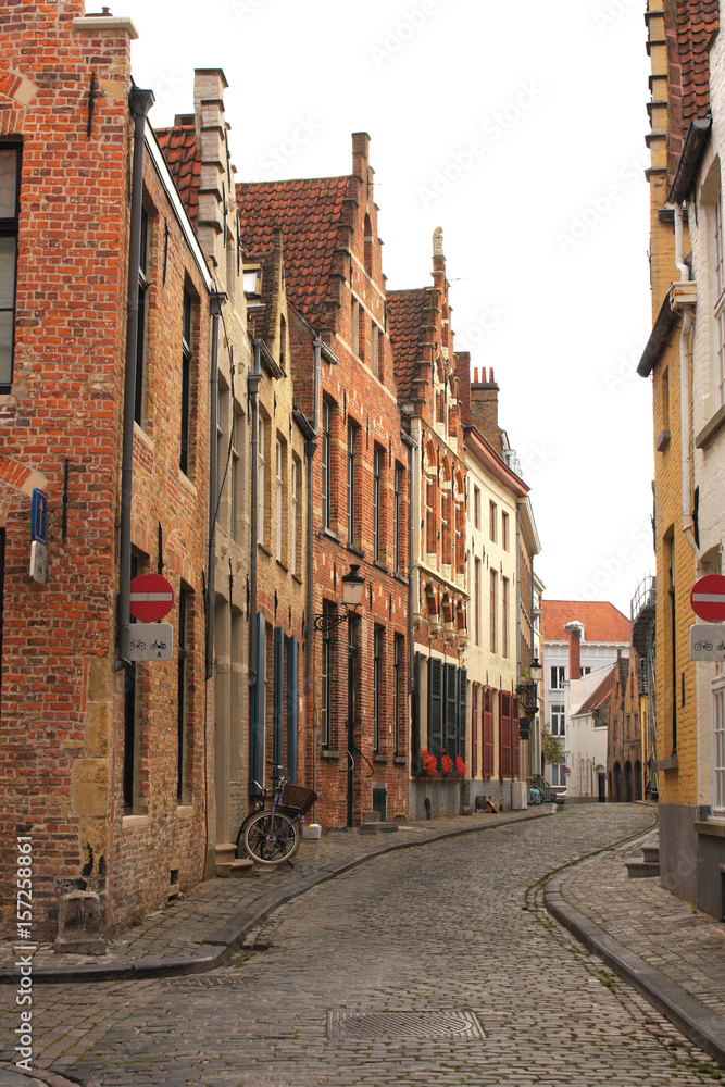 Fototapeta premium Street with historic medieval buildings, Bruges, Belgium