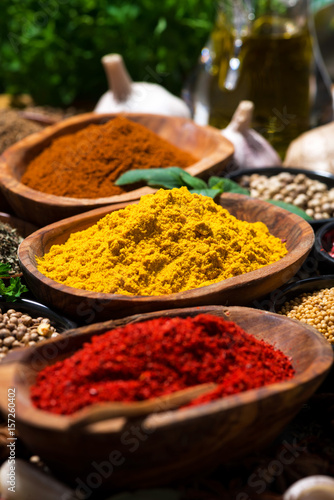 assortment of oriental spices on a wooden background, selective focus vertical