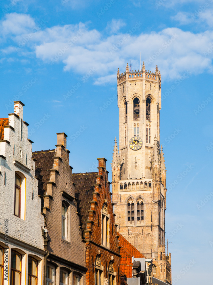 The Belfry Tower, aka Belfort, of Bruges, medieval bell tower in the historical centre of Bruges, Belgium. Close-up view of the top.