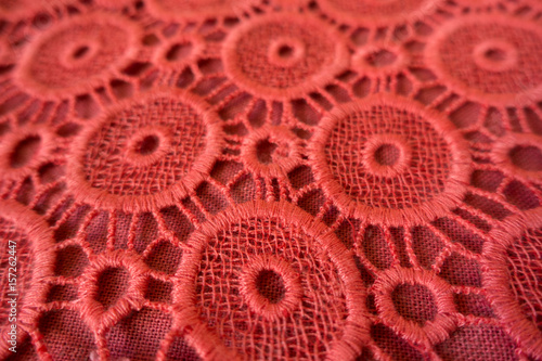 Close up of pinkish orange open embroidery