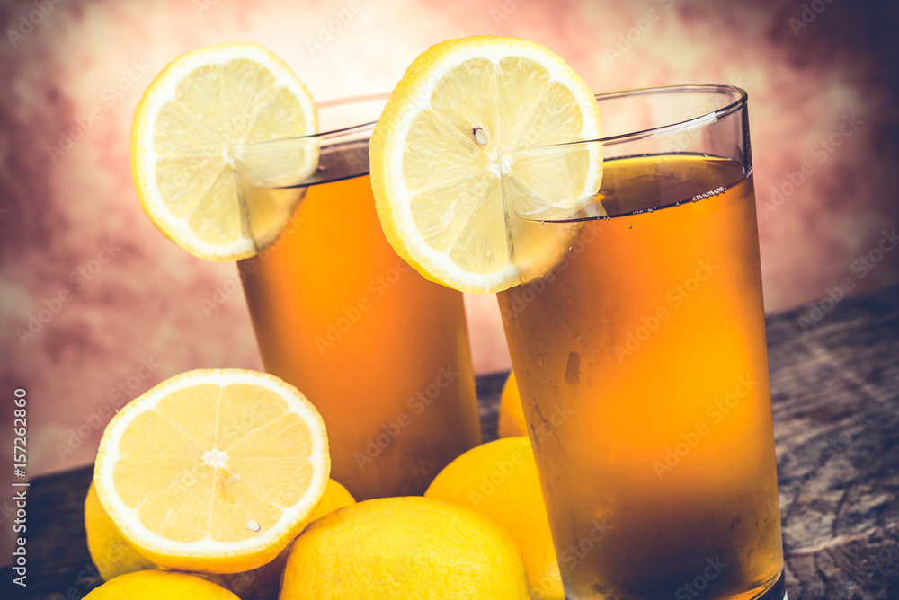 lemon ice tea on wooden table with lemons around lemon ice tea on wooden table with lemons around