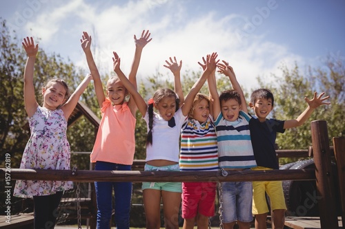 Tableau sur toile Happy schoolkids playing in playground