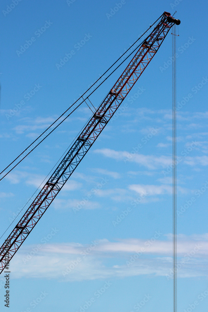 Crane arm on blue sky background