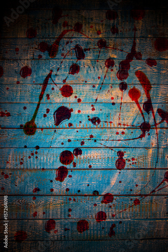Bloody spots on old wooden background.