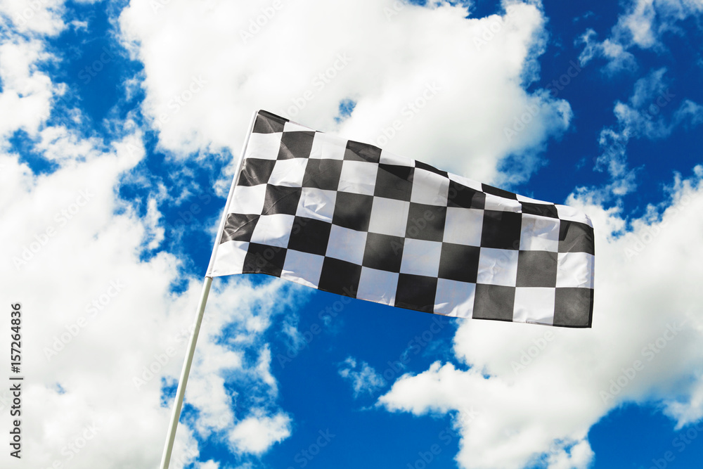 Checkered flag waving in the wind. Filtered image: cross processed vintage effect.