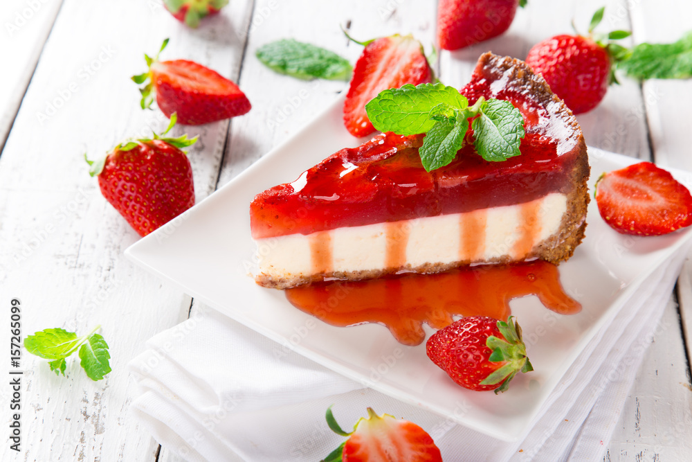 Delicious cheesecake with strawberries on wooden table. Delicious cheesecake with strawberries on wooden table.