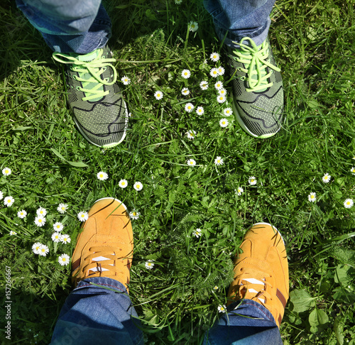 sports shoes on green grass © Sergiy Serdyuk
