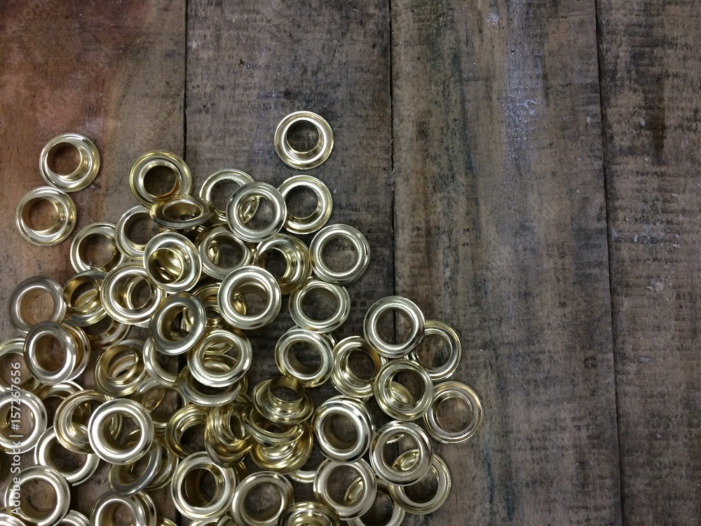 Gold Eyelet Ring on Wood Table Gold Eyelet Ring on Wood Table