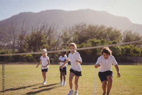 Schoolgirls running toward finishing line 