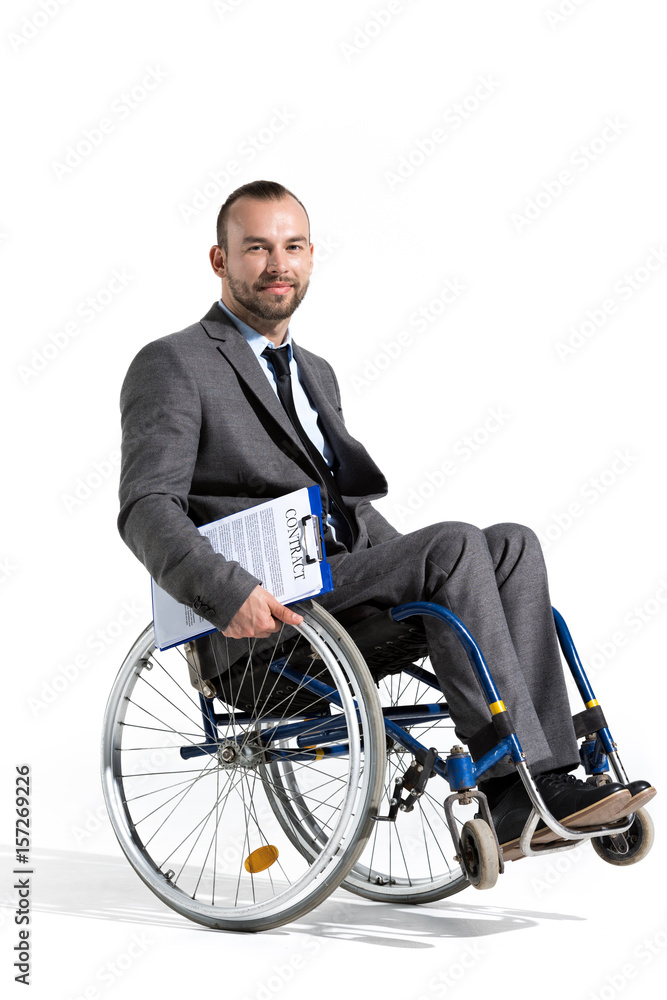 physically handicapped businessman in wheelchair looking at camera with contract physically handicapped businessman in wheelchair looking at camera with contract