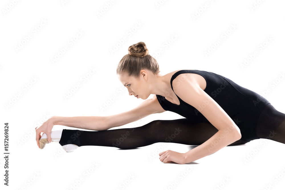 Attractive young sportswoman training and stretching isolated on white