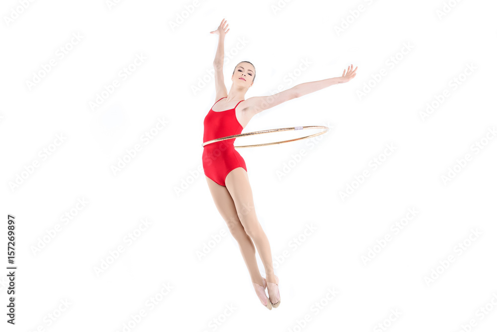 Sportive rhythmic gymnast training with hoop on waist isolated on white