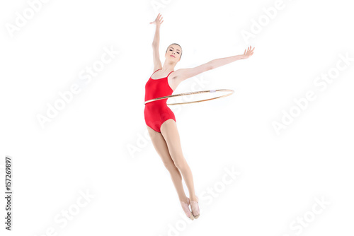 Sportive rhythmic gymnast training with hoop on waist isolated on white © LIGHTFIELD STUDIOS