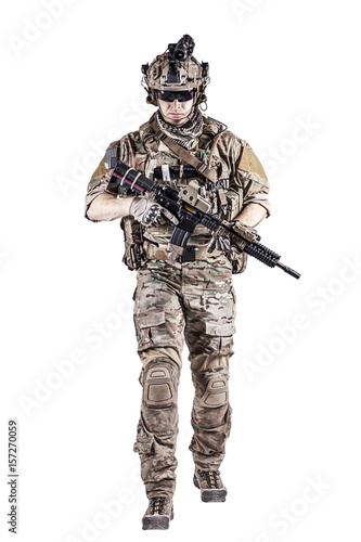 US Army rangers in combat uniforms with his shirt sleeves rolled up, in helmet, eyewear and night vision goggles moving walking towards camera. Studio shot, white background © Getmilitaryphotos