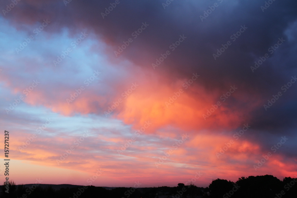 Beautiful sunset with pink and orange clouds. Evening sky background.