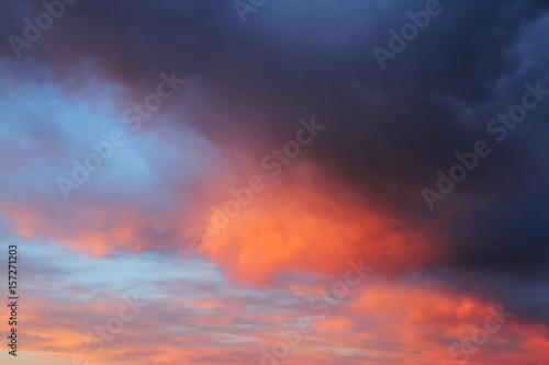 Beautiful sunset with pink and orange clouds. Evening sky background. © iluuuhina