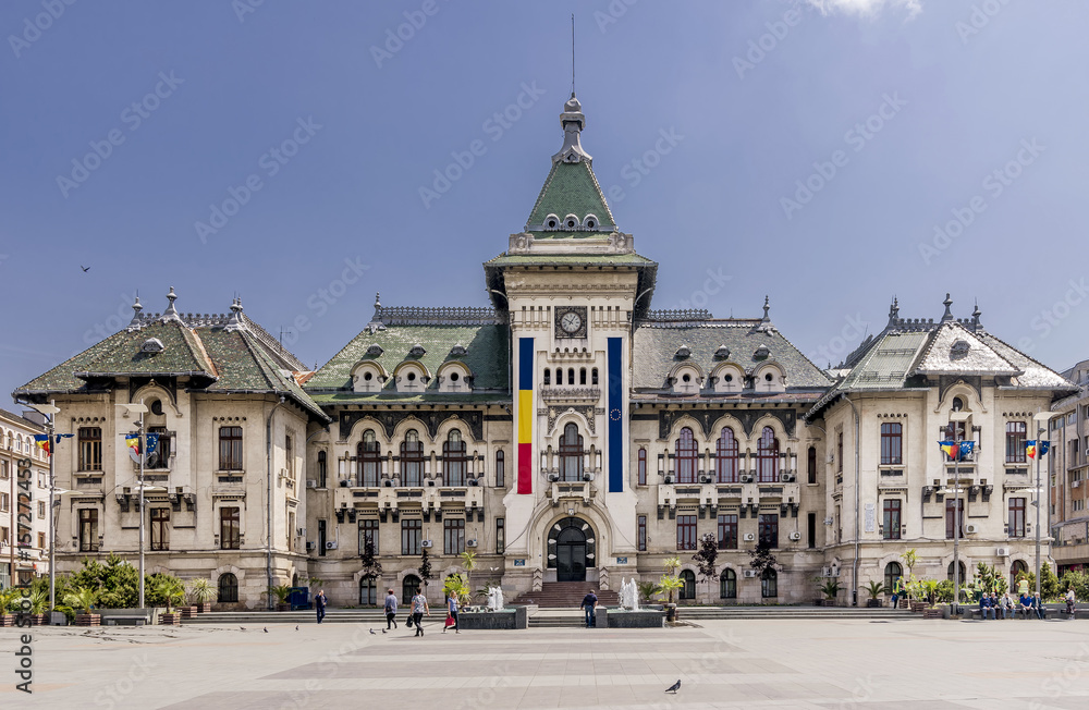 The facade of the Administrative Palace of Craiova (today Dolj Prefecture and County Council), an imposing historical monument located on the territory of Craiova, Romania, on a sunny day